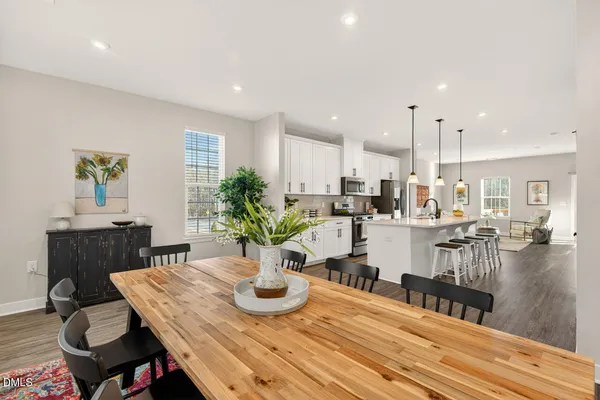 a view of a a dining room with furniture window and wooden floor