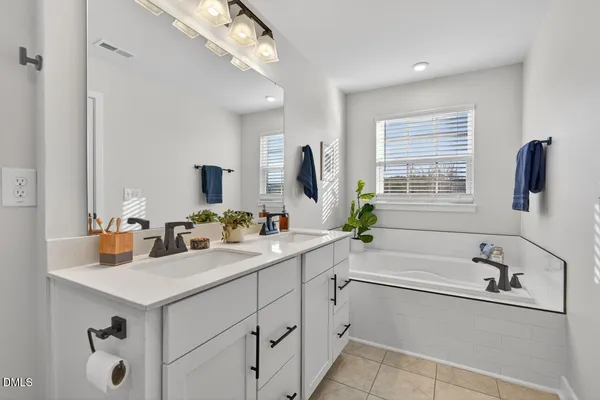 a white bath tub sitting next to a window