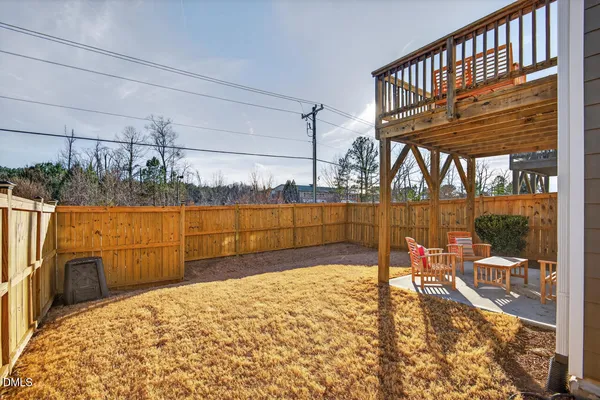a view of a house with large area and wooden fence