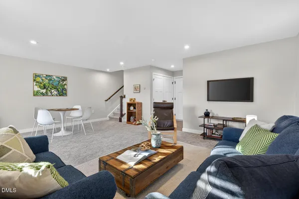 a white chair sitting in a room next to a window
