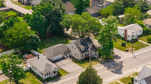 an aerial view of a house with garden space and street view