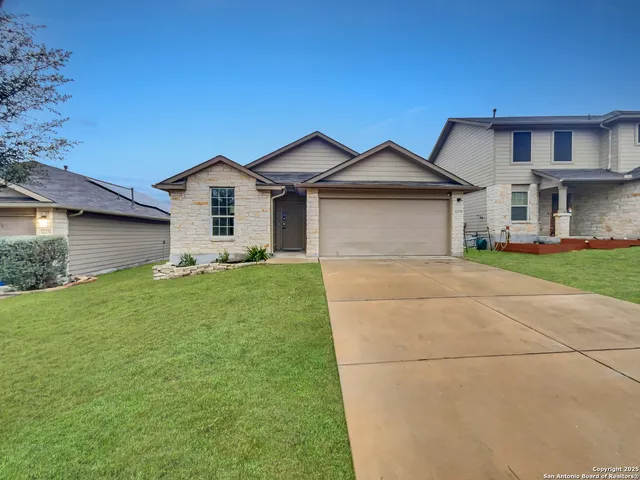 a front view of house with yard and green space