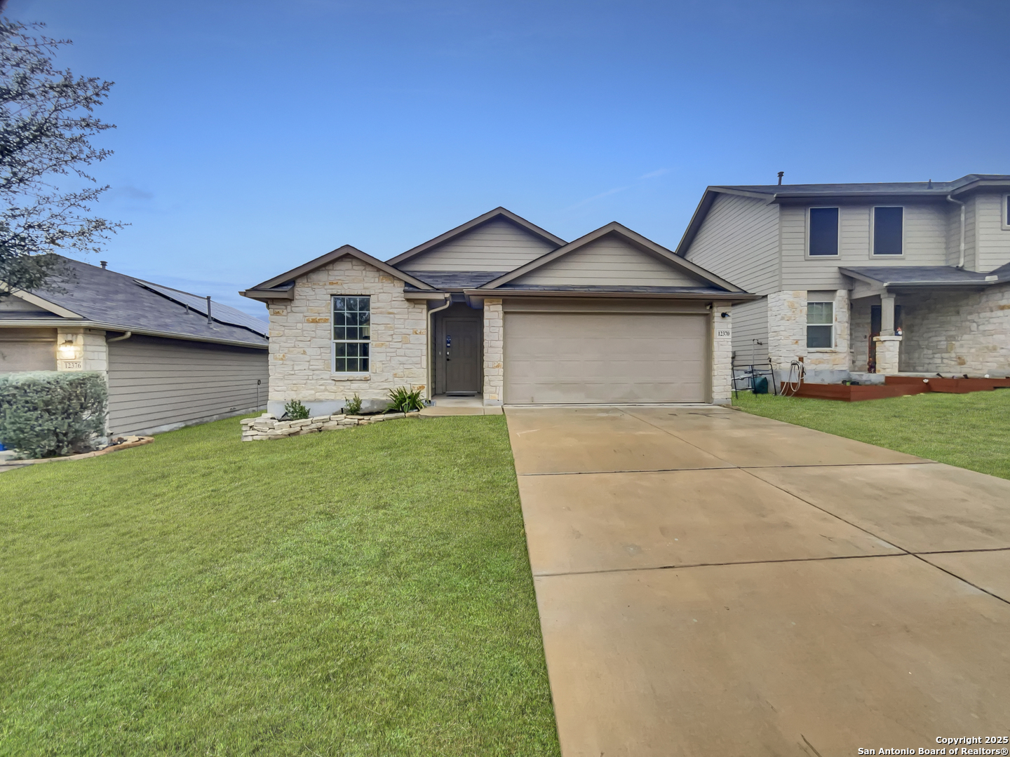 a front view of house with yard and green space
