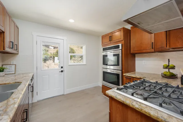 a kitchen with stainless steel appliances granite countertop a stove and a sink