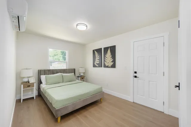 a bedroom with a bed and a window