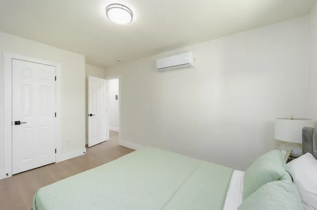 a bedroom with a bed and a table