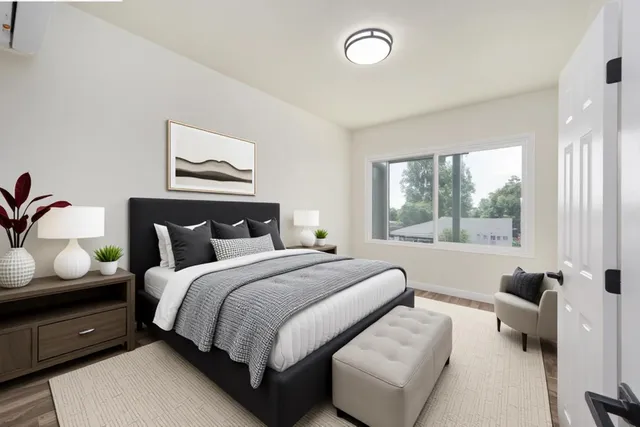 a bedroom with bed and wooden floor