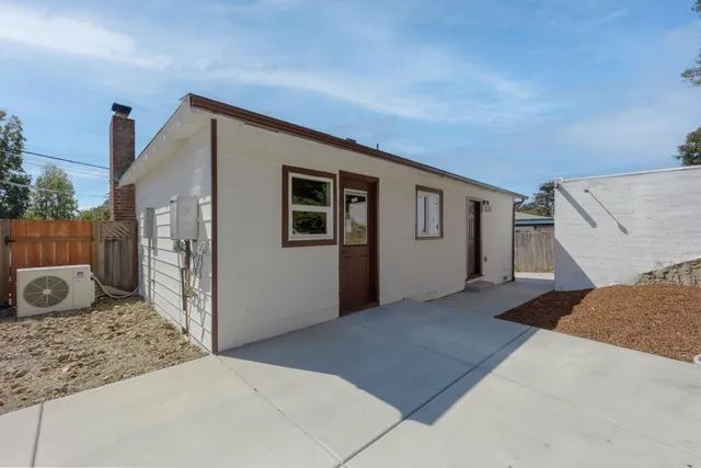 a view of a house with a backyard and garage