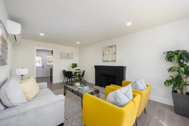 a living room with furniture potted plant and a fireplace