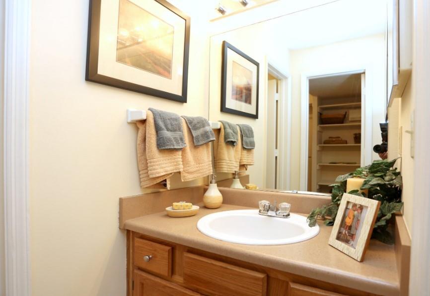 3450 K Jones Mill Road, Unit 218 Norcross, GA 30092 - Photo 12 of 29 a bathroom with a granite countertop sink and a mirror