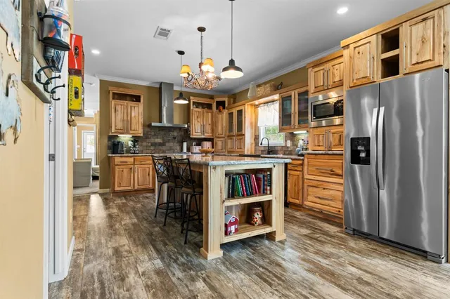 a kitchen with stainless steel appliances granite countertop a refrigerator and a stove