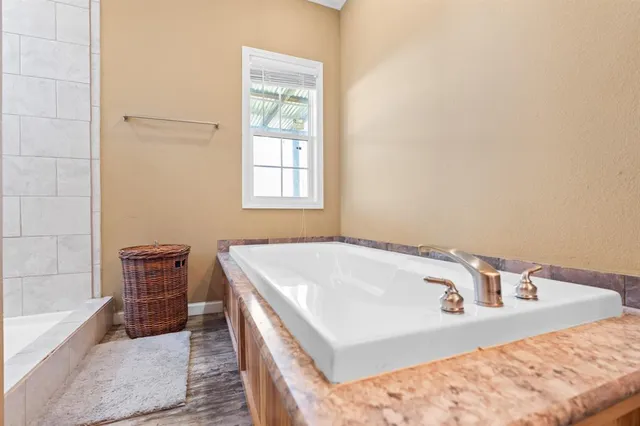a bath tub sitting in a bathroom next to a window
