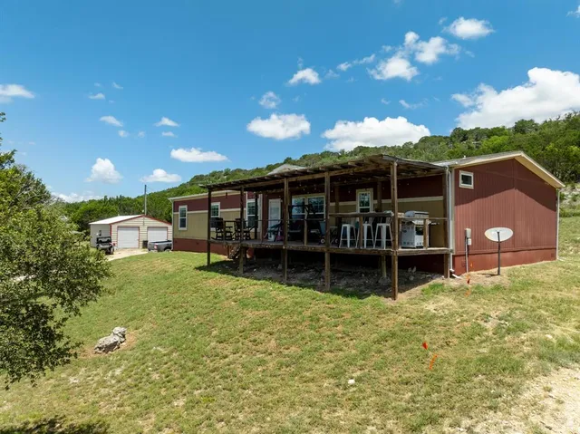 a view of a house with a yard porch and sitting area