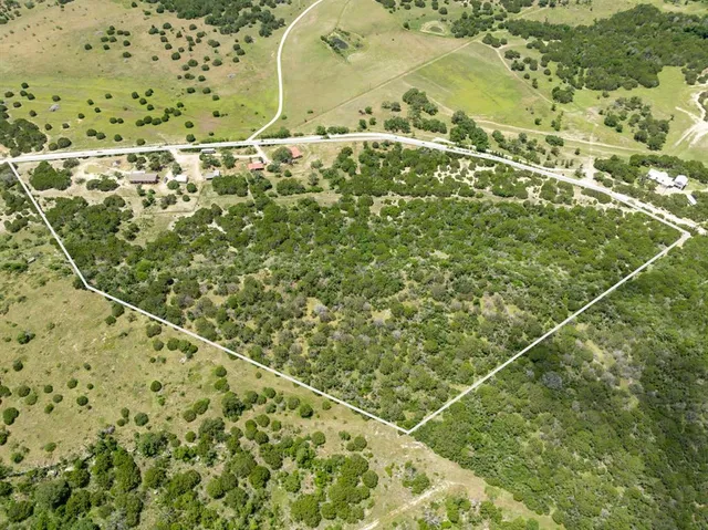 a view of a garden with a house in the background