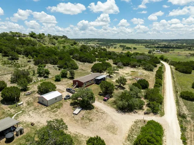 a aerial view of a house with a yard and sitting area