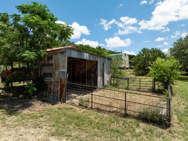 an aerial view of residential house with an outdoor space and seating area