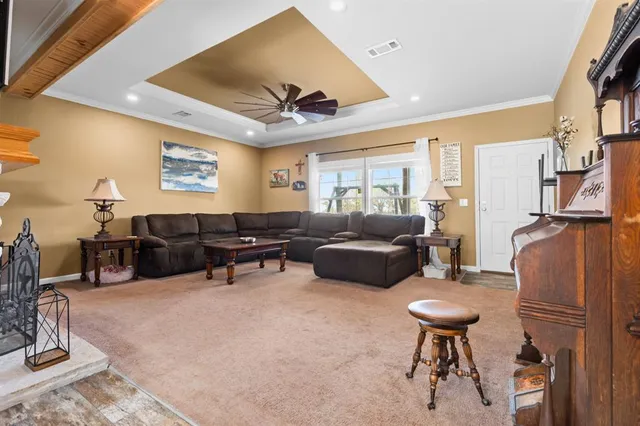 a living room with furniture a ceiling fan and a rug