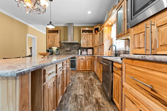 a kitchen with stainless steel appliances a sink stove and cabinets