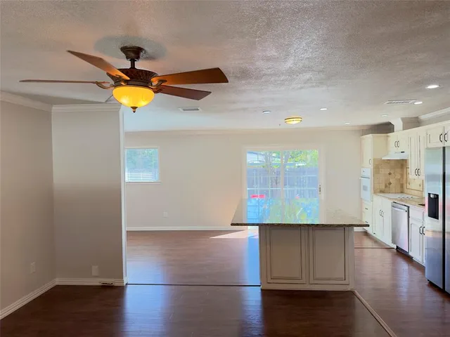 a view of a kitchen with a sink and a stove top oven