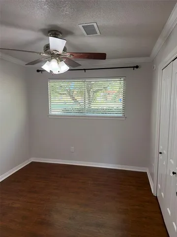 a view of room with window ceiling fan and hardwood floor