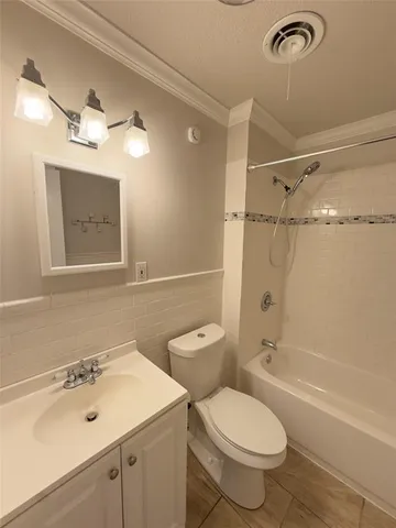 a bathroom with a sink toilet tub and shower