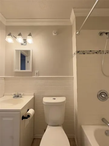 a bathroom with a toilet sink shower and mirror