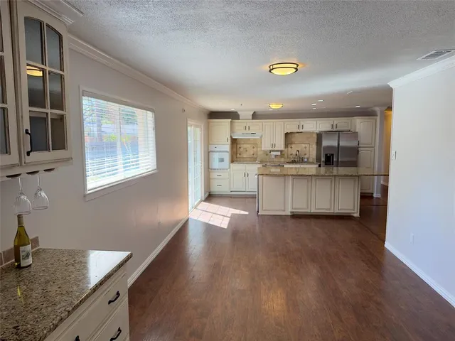 a kitchen with stainless steel appliances granite countertop a stove and a sink