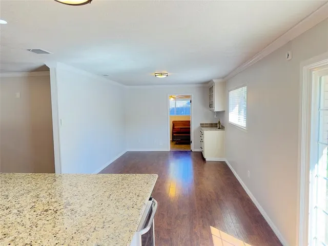 a view of a kitchen with wooden floor and a sink