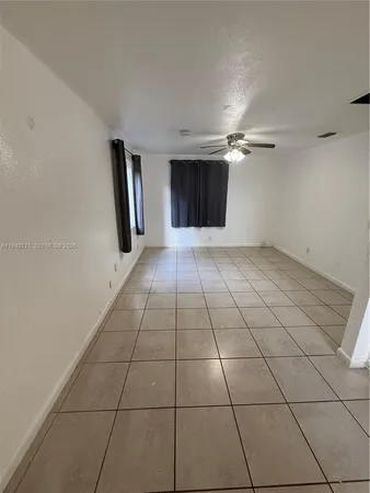 a view of an empty room with a fireplace