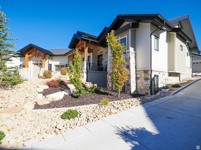 3167 South Mapleton Estates Drive Mapleton, UT 84664 - Photo 3 of 42 View of property exterior featuring stone siding and a porch