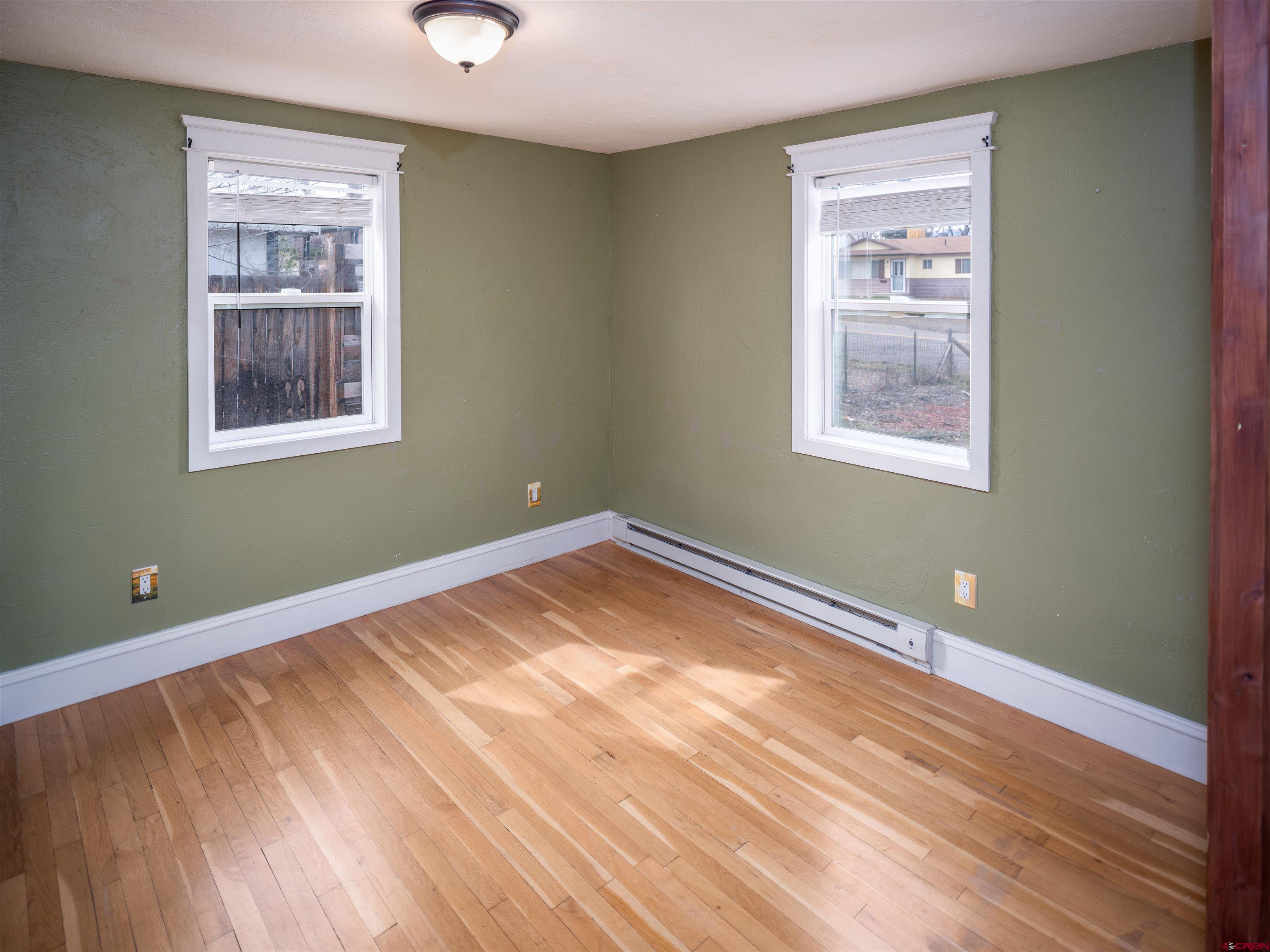 312 North Beech Street Cortez, CO 81321 - Photo 11 of 37 a view of an empty room with wooden floor and a window