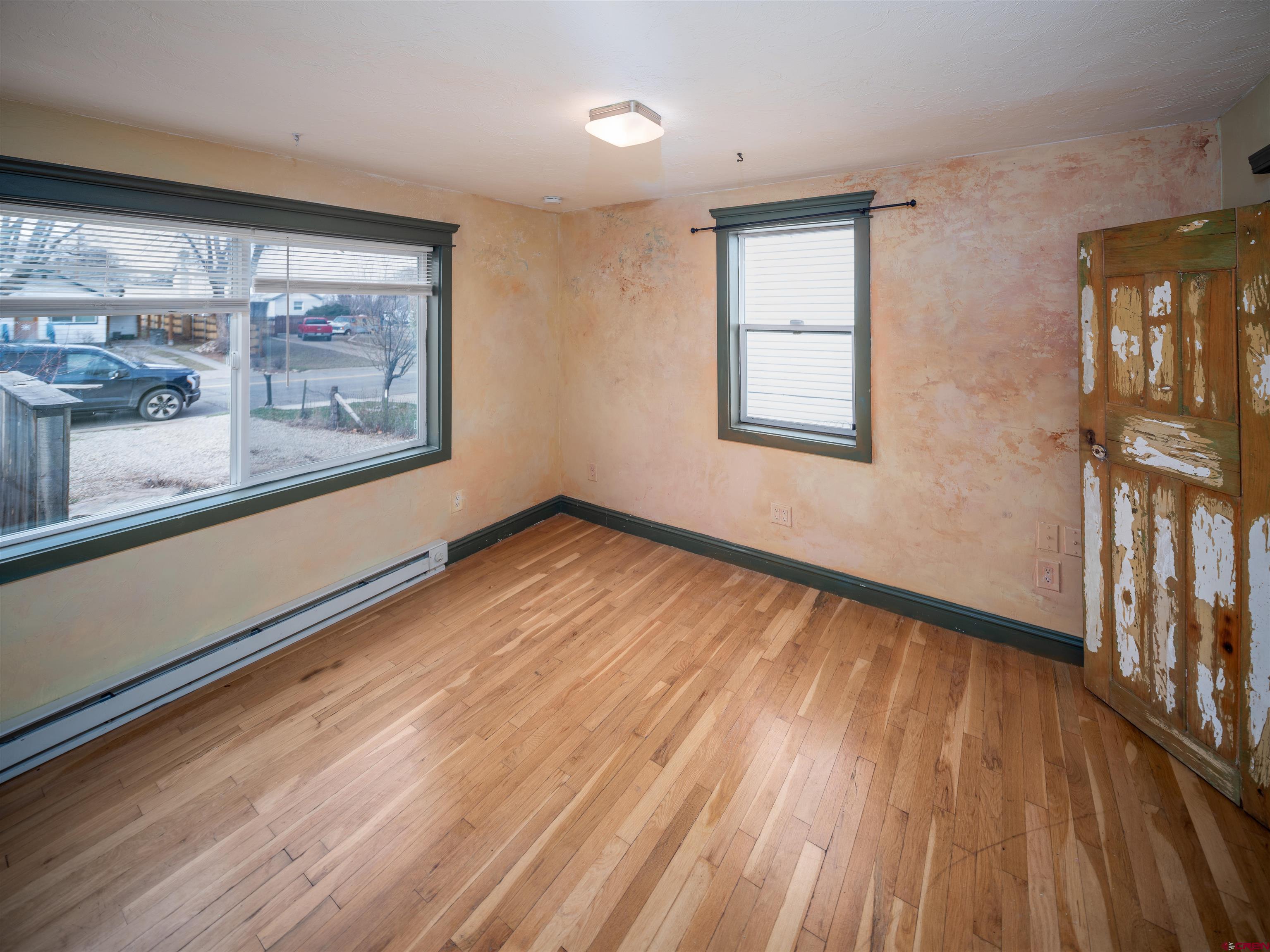 312 North Beech Street Cortez, CO 81321 - Photo 15 of 37 a view of an empty room with wooden floor and a window