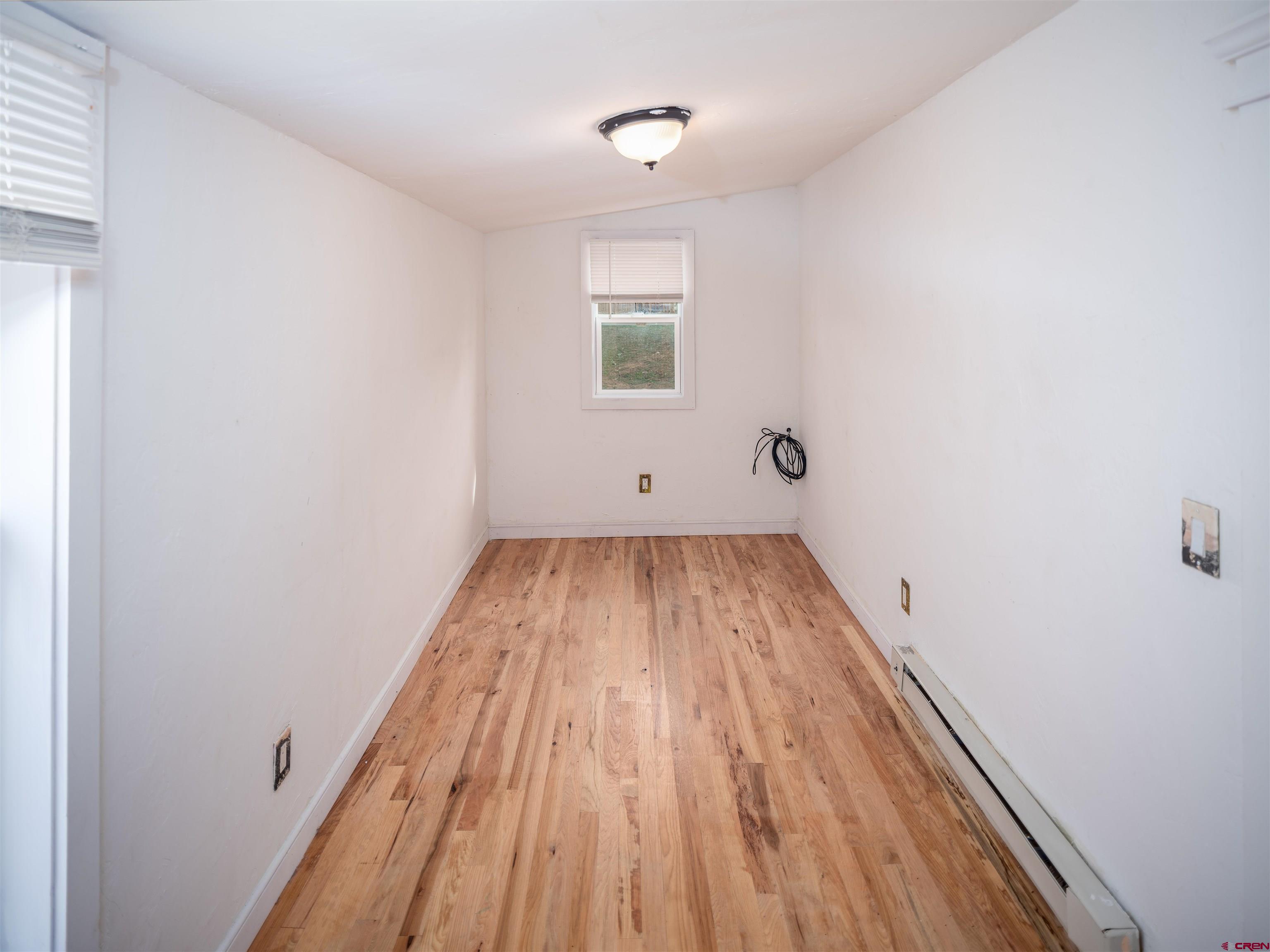 312 North Beech Street Cortez, CO 81321 - Photo 16 of 37 a view of a room with wooden floor and white walls
