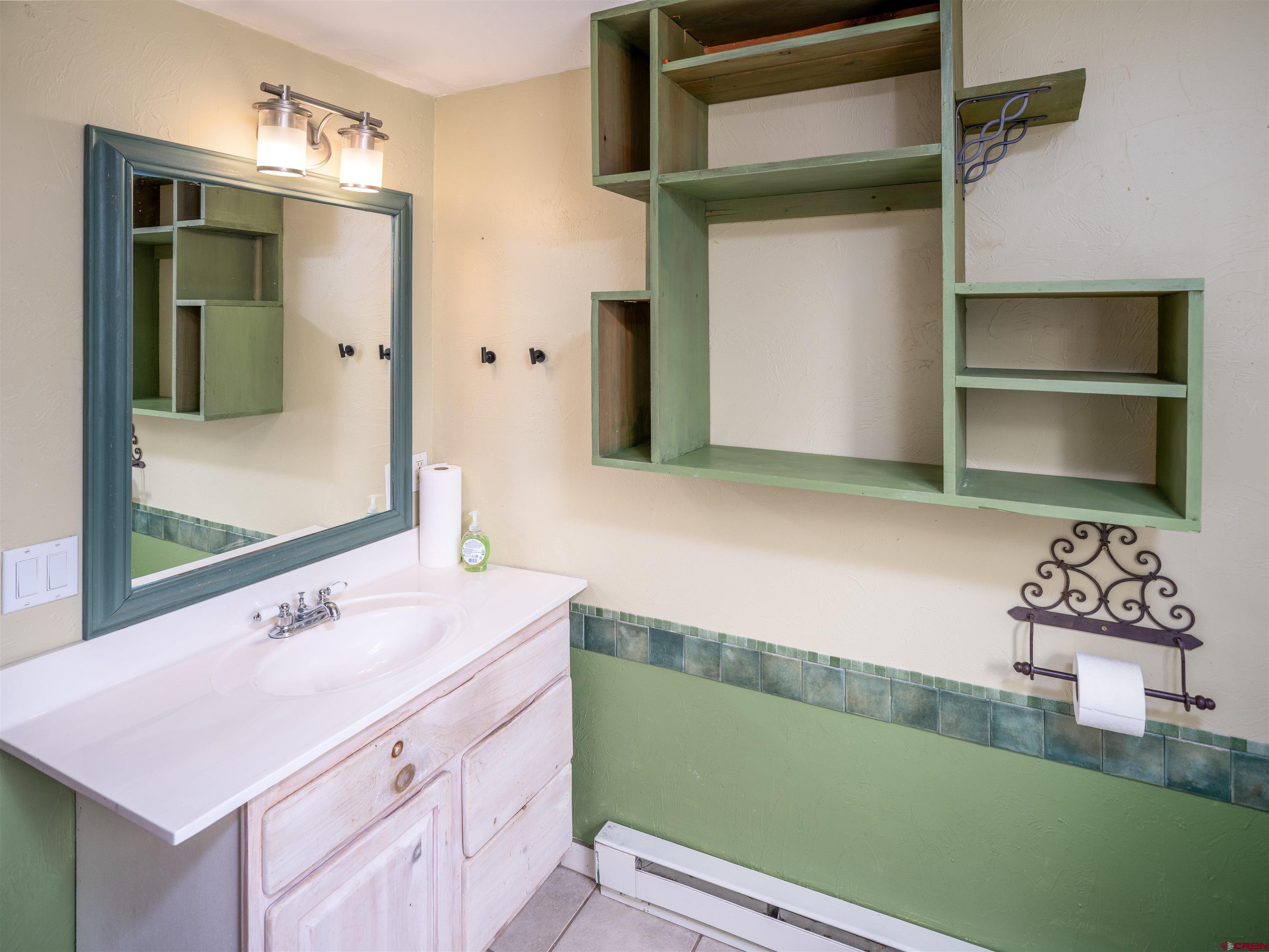 312 North Beech Street Cortez, CO 81321 - Photo 17 of 37 a bathroom with a sink and a mirror