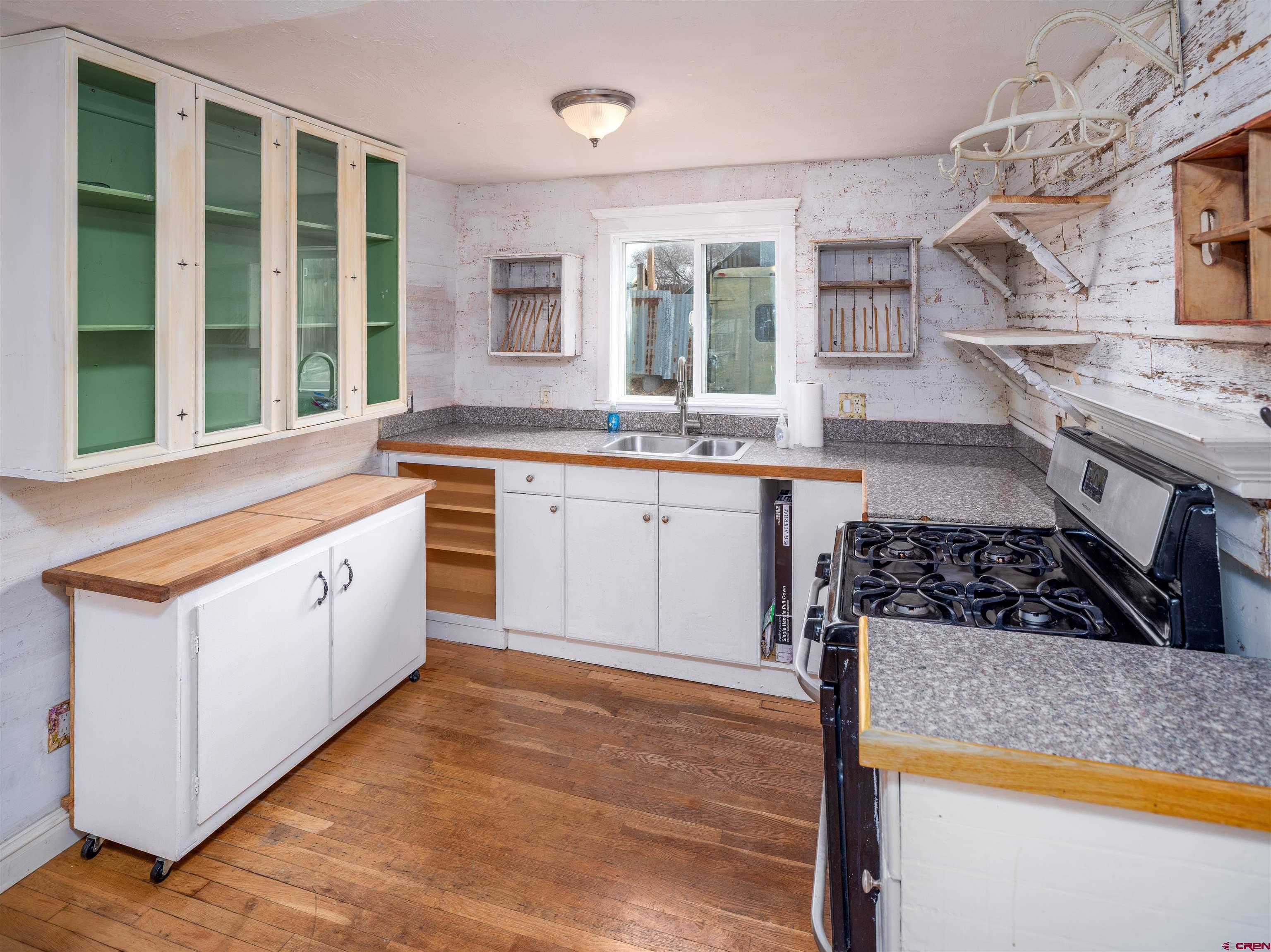 312 North Beech Street Cortez, CO 81321 - Photo 20 of 37 a kitchen with stainless steel appliances granite countertop a stove a sink and a refrigerator