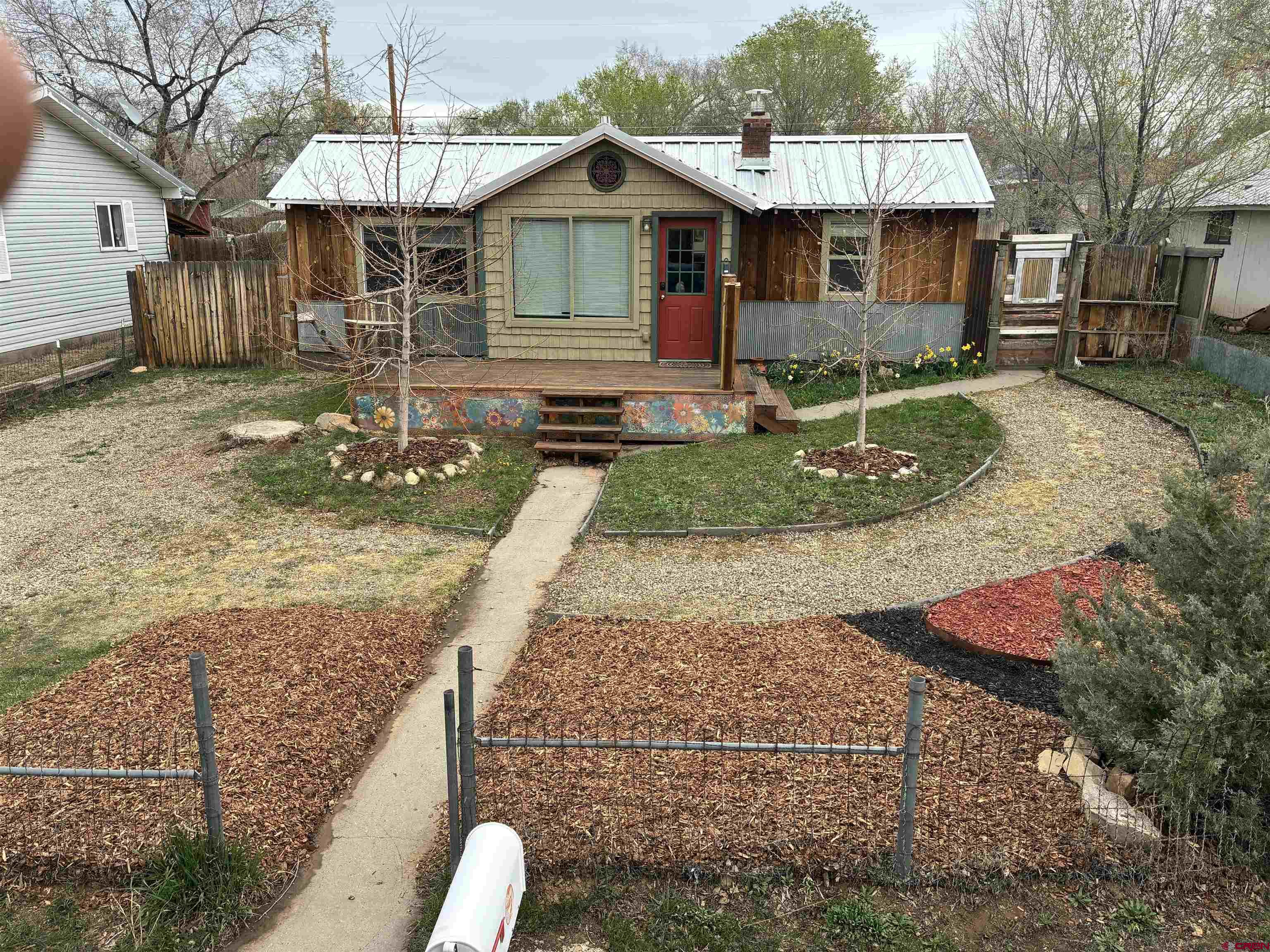 312 North Beech Street Cortez, CO 81321 - Photo 2 of 37 a front view of a house with garden