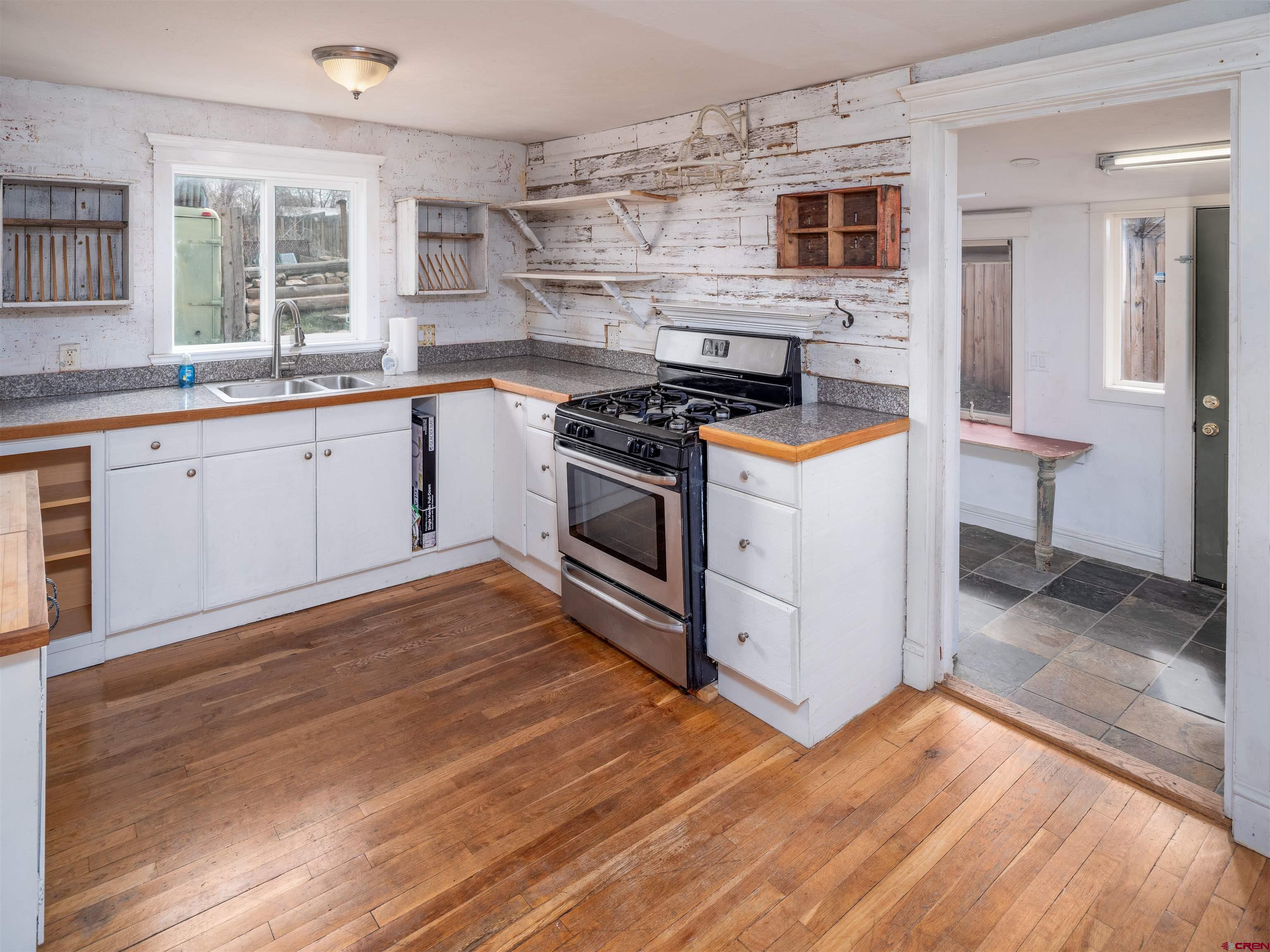 312 North Beech Street Cortez, CO 81321 - Photo 22 of 37 a kitchen with stainless steel appliances granite countertop a stove and a sink