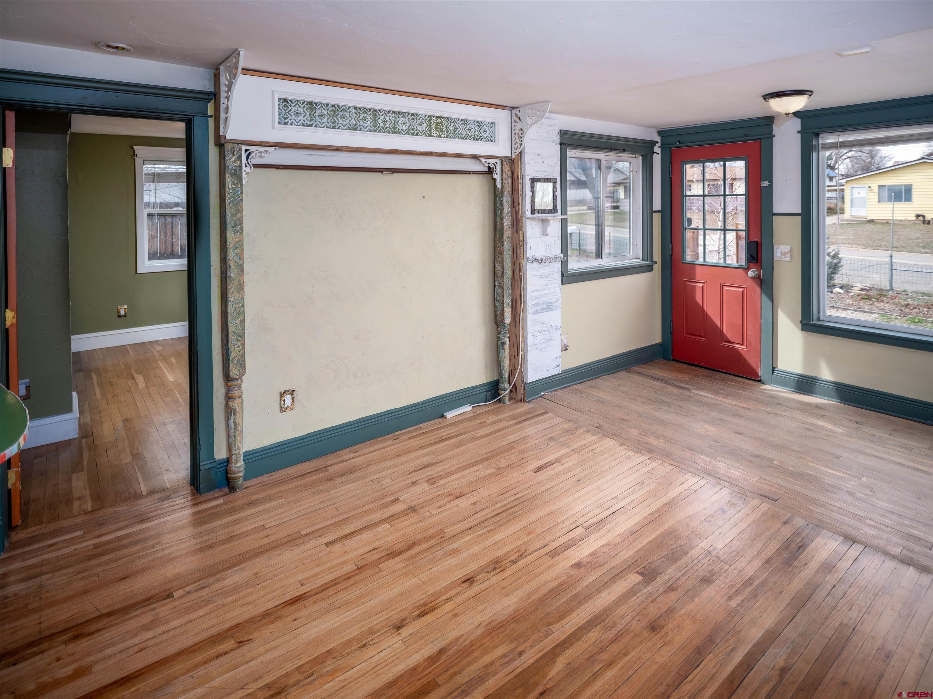 312 North Beech Street Cortez, CO 81321 - Photo 9 of 37 a view of an empty room with wooden floor and a window