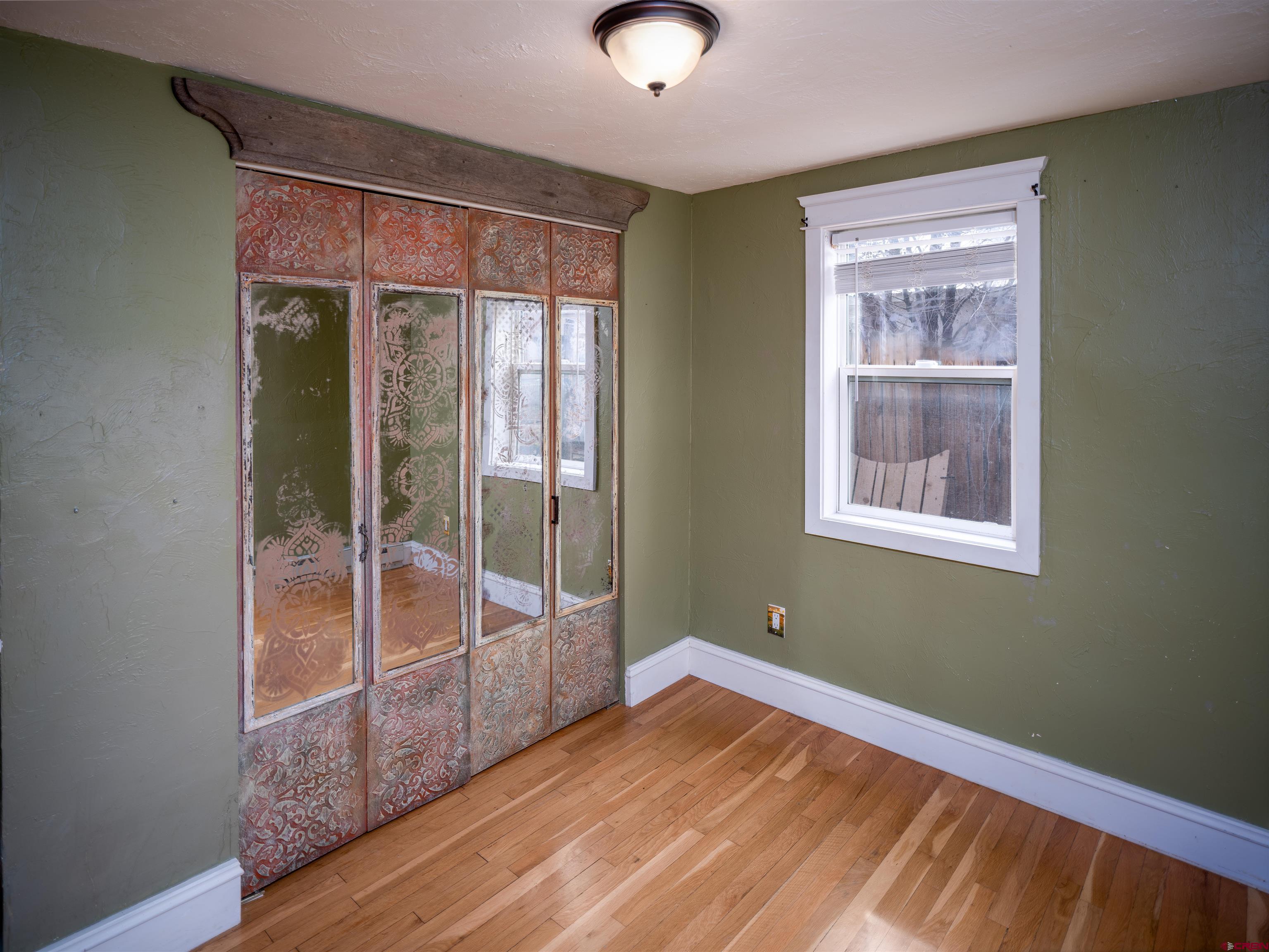 312 North Beech Street Cortez, CO 81321 - Photo 10 of 37 a view of empty room with wooden floor and fan