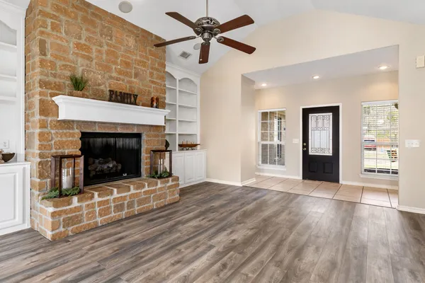 a view of a livingroom with a fireplace and wooden floor