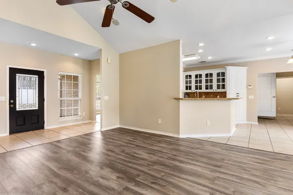 a view of a kitchen with wooden floor and windows