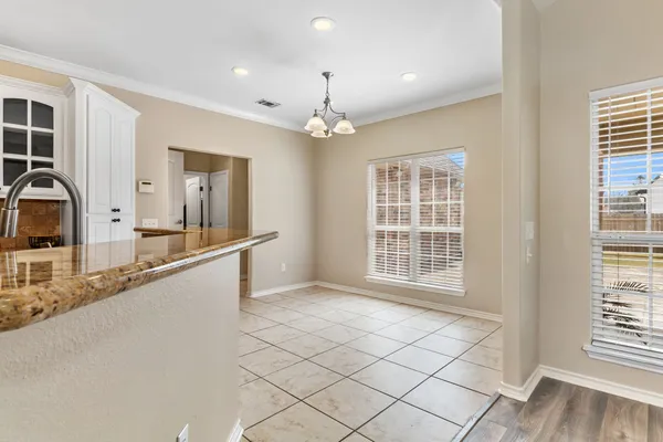 a large kitchen with granite countertop a large window and a sink