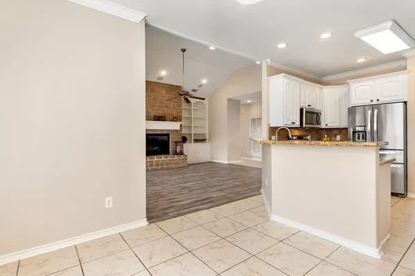 a kitchen with stainless steel appliances a refrigerator and a stove top oven