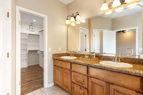 a bathroom with a granite countertop sink and a mirror