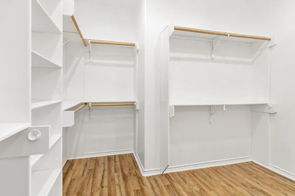 a view of walk in closet with empty racks