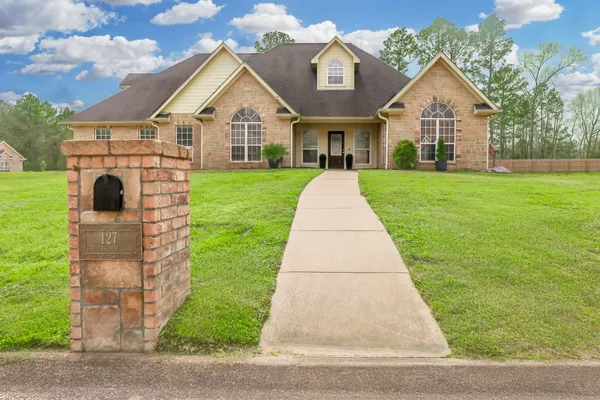 a front view of a house with a yard