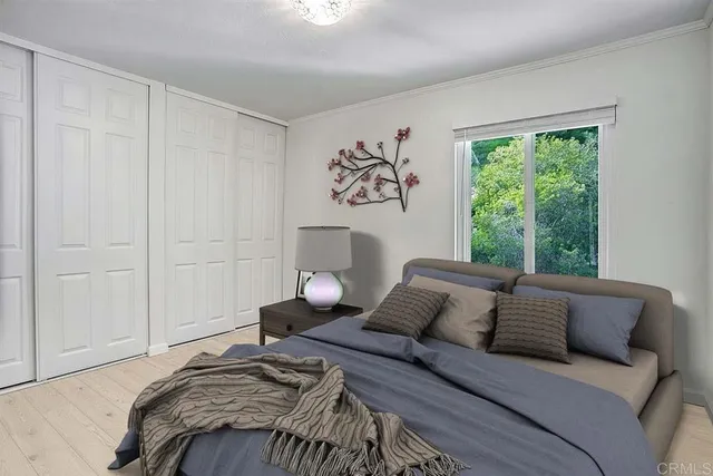 a bedroom with a bed and a window