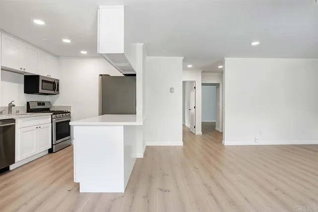 a view of a kitchen with a sink and a stove top oven