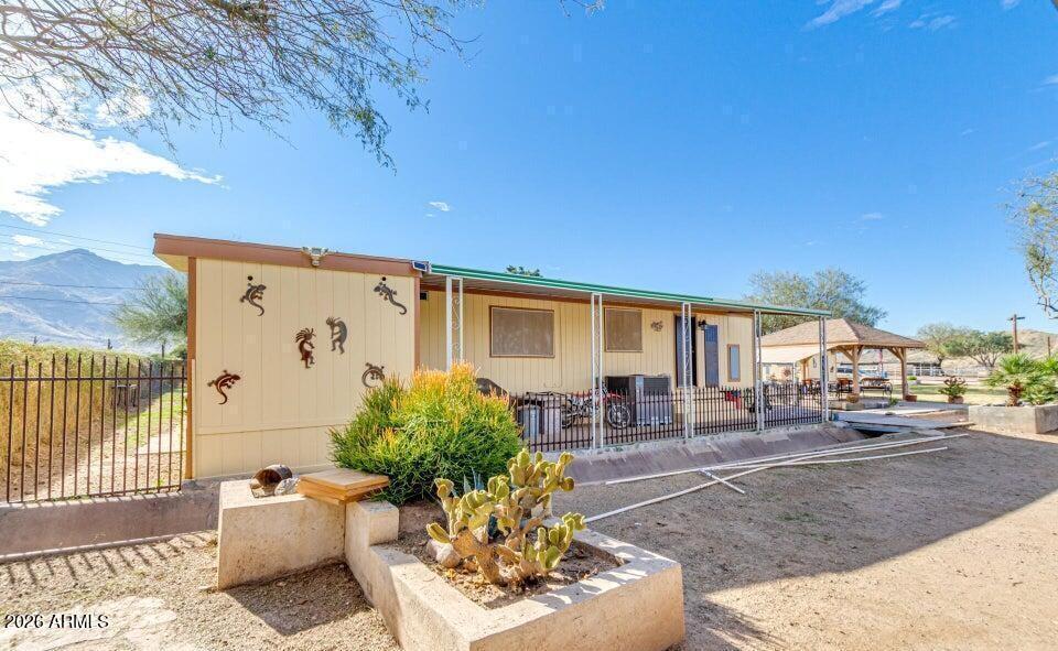 3232 West Carver Road Laveen, AZ 85339 - Photo 3 of 6 a house view with a sitting space fire pit and outdoor space