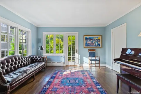 a living room with furniture rug and a large window